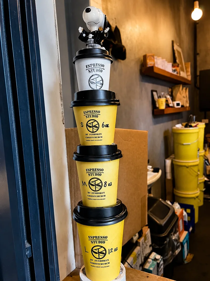 Stacked Espresso Studio takeaway cups at the counter
