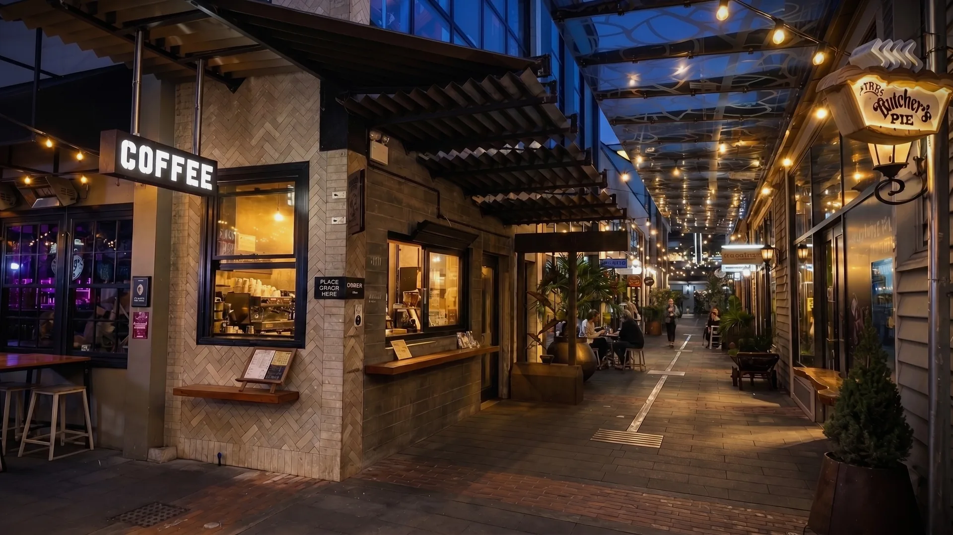 Night-time café lane with an illuminated coffee sign