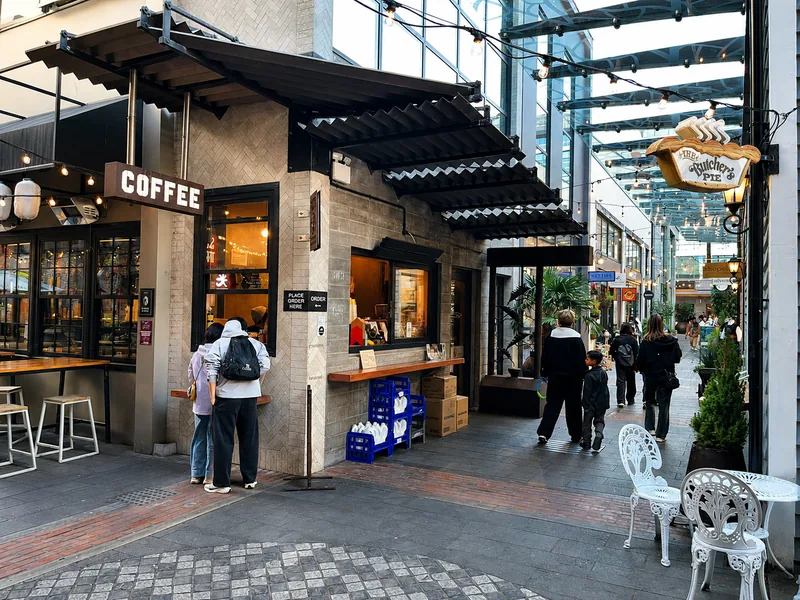 Coffee window and visitors in the Riverside Market laneway